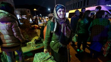 An ethnic Armenian woman from Nagorno-Karabakh carries her suitcase to a tent camp after arriving to Armenia's Goris in Syunik region, Armenia, late Friday, Sept. 29, 2023. Armenian officials say that by Friday evening over 97,700 people had left Nagorno-Karabakh. The region's population was around 120,000 before the exodus began. (AP Photo/Vasily Krestyaninov)