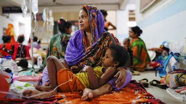 A dengue infected child lies on her mother's lap while receiving treatment at Mugda Medical College and Hospital in Dhaka, Bangladesh, July 5, 2023.REUTERS/Mohammad Ponir Hossain