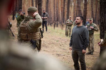 This handout photograph taken and released by the Ukrainian Presidential Press Service on October 3, 2023 shows Ukrainian President Volodymyr Zelenskyy (R) visiting the location of the 103rd Separate Brigade of the Territorial Defense Forces of the Armed Forces of Ukraine, the 68th Separate Yeger Brigade, and the 25th Separate Sicheslav Airborne Brigade, which are performing combat missions in the Kupyansk-Lyman area, in Kharkiv region. (AFP)