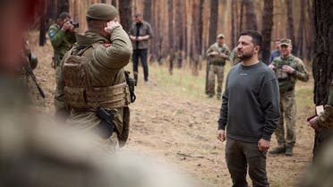 This handout photograph taken and released by the Ukrainian Presidential Press Service on October 3, 2023 shows Ukrainian President Volodymyr Zelenskyy (R) visiting the location of the 103rd Separate Brigade of the Territorial Defense Forces of the Armed Forces of Ukraine, the 68th Separate Yeger Brigade, and the 25th Separate Sicheslav Airborne Brigade, which are performing combat missions in the Kupyansk-Lyman area, in Kharkiv region. (AFP)