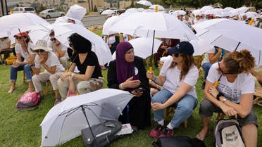 Activists from various local and foreign NGOs gather around the Tolerance Monument in a park in Jerusalem, as they take part in a joint event organised by the Israeli “Women Wage Peace” and the Palestinian “Women of the Sun” movements, demanding an end to the cycle of bloodshed and a solution to the Palestinian-Israeli conflict, on October 4, 2023. (AFP)