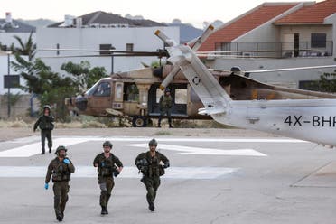 Israeli soldiers are seen near a military helicopter at a hospital following a mass-infiltration by Hamas gunmen from the Gaza Strip, in Ashkelon, southern Israel October 7, 2023. (Reuters)