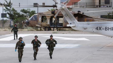 Israeli soldiers are seen near a military helicopter at a hospital following a mass-infiltration by Hamas gunmen from the Gaza Strip, in Ashkelon, southern Israel October 7, 2023. (Reuters)