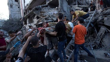 Palestinians rescue a man from the rubble of a destroyed residential building following an Israeli airstrike, Tuesday, Oct. 10, 2023. (AP)