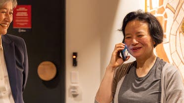 Australian journalist Cheng Lei speaks on the phone, on arrival at Melbourne Airport in Melbourne, on October 11, 2023. (Reuters)