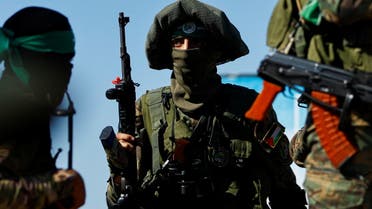 Palestinian fighters from the armed wing of Hamas take part in a military parade to mark the anniversary of the 2014 war with Israel, in the central Gaza Strip, July 19, 2023. (Reuters)