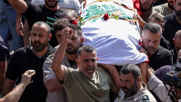 Mourners carry the body of Issam Abdallah, a Lebanese national and Reuters videojournalist who was killed in southern Lebanon by shelling from the direction of Israel, during his funeral in his home town of Al Khiyam, Lebanon October 14, 2023. REUTERS/Zohra Bensemra