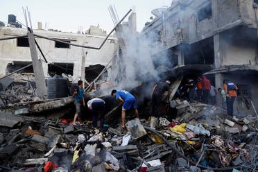 Palestinians search for casualties under the rubble in the aftermath of Israeli strikes, amid the ongoing conflict between Israel and the Palestinian group Hamas, in Khan Younis in the southern Gaza Strip, on October 14, 2023. (Reuters)