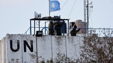 Members of the United Nations peacekeepers (UNIFIL) look at the Lebanese-Israeli border, as they stand on the roof of a watch tower ‏in the town of Marwahin, in southern Lebanon, October 12, 2023. (Reuters)
