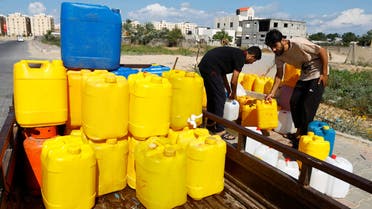 Palestinians collect water, amid shortages of drinking water, as the Israeli-Palestinian conflict continues, in Khan Younis in the southern Gaza Strip October 15, 2023. REUTERS/Ibraheem Abu Mustafa