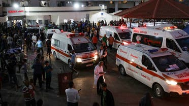 Ambulances carrying victims of Israeli strikes crowd the entrance to the emergency ward of the Al-Shifa hospital in Gaza City on October 15, 2023. (AFP)