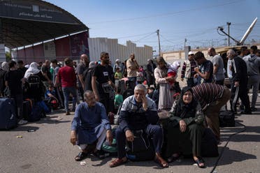 Palestinians wait to cross into Egypt at the Rafah border crossing in the Gaza Strip on Monday, Oct.16, 2023. (AP)