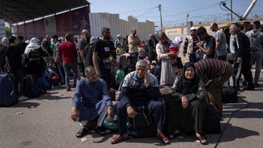 Palestinians wait to cross into Egypt at the Rafah border crossing in the Gaza Strip on Monday, Oct.16, 2023. (AP)