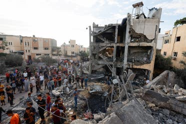 Palestinians search for casualties under the rubble of a building destroyed by Israeli strikes in Khan Younis in the southern Gaza Strip, October 17, 2023. (Reuters)