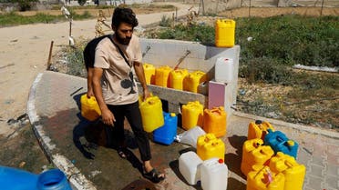 Palestinians collect water, amid shortages of drinking water, as the Israeli-Palestinian conflict continues, in Khan Younis in the southern Gaza Strip October 15, 2023. (Reuters)