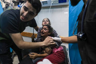 Children injured in an Israeli airstrike react as they receive treatment in the Nasser hospital in Khan Yunis in the southern of Gaza Strip, on October 17, 2023. (AFP) 