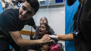 Children injured in an Israeli airstrike react as they receive treatment in the Nasser hospital in Khan Yunis in the southern of Gaza Strip, on October 17, 2023. (AFP) 