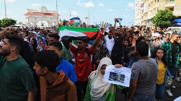 Egyptian students from the Alexandria University hold the Palestinian flag as they take part in a demonstration in northern Mediterranean coastal city of Alexandria on October 18, 2023, denouncing the killing of hundreds of Palestinians following a strike on a hospital in the Gaza Strip. (AFP)