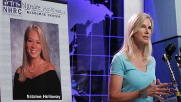 In this June 8, 2010 file photo, Beth Holloway, mother of Natalee Holloway, seen at poster on left, speaks during the opening of the Natalee Holloway Resource Center (NHRC) at the National Museum of Crime & Punishment in Washington. (AP)