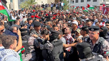 People confront members of security forces as they attempt to reach the Israeli embassy, during a pro-Palestinian protest after hundreds of Palestinians were killed in a blast at Al-Ahli hospital in Gaza that Israeli and Palestinian officials blamed on each other, in Amman, Jordan, on October 18, 2023. (Reuters)
