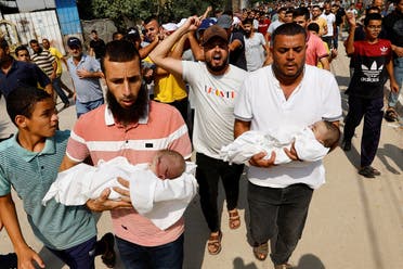  Mourners carry the bodies of Palestinian children from the al-Astal family, who were killed along with other family members in Israeli strikes, in Khan Younis, in the southern Gaza Strip October 22, 2023. REUTERS/Ibraheem Abu Mustafa