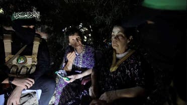 Yocheved Lifshitz and Nurit Cooper (also known as Nurit Yitzhak) who were held hostages by Palestinian Hamas militants, are released by the militants, in this video screengrab obtained by Reuters on October 23, 2023. (Reuters)