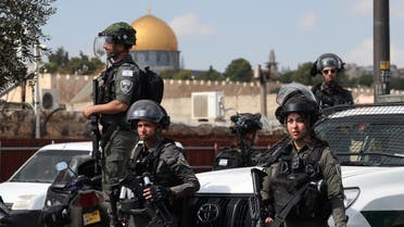 Israeli security forces look on as Muslim Palestinians take part in Friday Noon prayers in East Jerusalem neighborhood of Ras al-Amud, on October 20, 2023. (AFP)