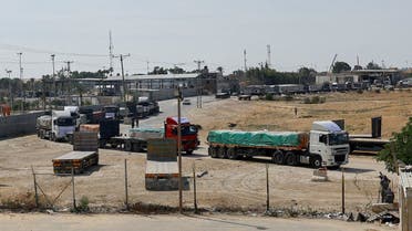 Trucks carrying aid wait to exit, on the Palestinian side of the border with Egypt, as the conflict between Israel and Palestinian Islamist group Hamas continues, in Rafah in the southern Gaza Strip, October 21, 2023. (Reuters)