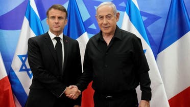 Israeli Prime Minister Benjamin Netanyahu (R) greets French President Emmanuel Macron before a meeting in Jerusalem on October 24, 2023. (Pool via AFP)