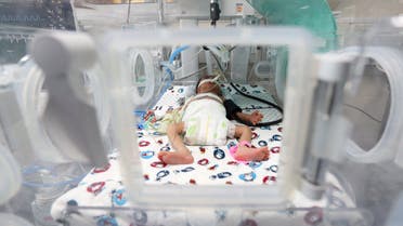 A premature Palestinian baby lies in an incubator at the maternity ward of Shifa Hospital, which according to health officials is about to shut down as it runs out of fuel and power, , in Gaza City October 22, 2023. (Reuters)