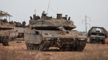 An Israeli tank and military vehicles are seen near Israel's border with the Gaza Strip, in southern Israel, October 22, 2023. (Reuters)