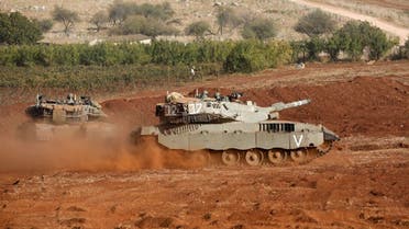 Israeli Merkava tanks take part in a military drill near the border with Lebanon in the upper Galilee region of northern Israel on October 26, 2023, amid the ongoing battles between Israel and the Palestinian group Hamas in the Gaza Strip. (AFP)
