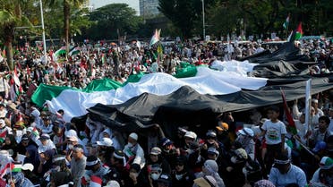 Protesters shout slogans as they unfurl Palestinian flags during a rally supporting the Palestinian people, outside the U.S. Embassy in Jakarta, Indonesia, Saturday, October 28, 2023. (AP)