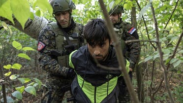 Serbian gendarmerie officers detain a migrant close to the Serbia-Hungary border, near the city of Subotica, Serbia September 12, 2023. REUTERS/Marko Djurica