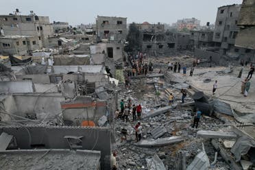 Palestinians gather at the site of Israeli strikes on houses and a mosque in the central Gaza Strip, October 29, 2023. (Reuters)