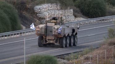 A picture taken from Israel’s southern city of Sderot shows an Israeli army APC advancing on a road by the Gaza border, on October 29, 2023, amid ongoing battles between Israel and the Palestinian Hamas movement. (AFP)