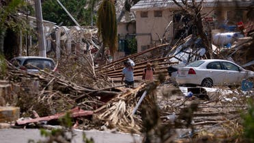 FILE PHOTO: People walk next to rubble and damaged trees in the aftermath of Hurricane Otis, in Acapulco, Mexico, October 29, 2023. REUTERS/Quetzalli Nicte-Ha/File Photo