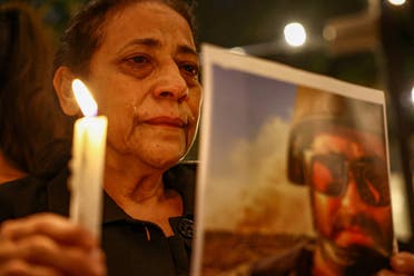 Aunt of Issam Abdallah, a Reuters video journalist who was killed in southern Lebanon while filming an Israeli tank firing into Lebanon, reacts during a candlelight vigil, in Beirut, Lebanon, October 20, 2023. (File photo: Reuters)