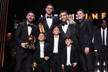 Inter Miami CF's Argentine forward Lionel Messi (L) poses with his trophy and his children (bottom), and with Aston Villa's goalkeeper Emiliano Martinez (Top 2ndL), Inter Milan's Argentine forward Lautaro Martinez and Manchester City's Argentine forward Julian Alvarez during the 2023 Ballon d'Or France Football award ceremony at the Theatre du Chatelet in Paris on October 30, 2023. (AFP)