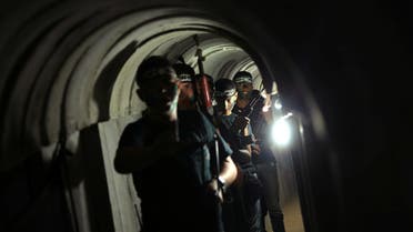 Young Palestinians holding weapons walk in a tunnel during a military exercise graduation ceremony at a summer camp organised by Hamas's armed wing, east of Gaza City July 22, 2016. (File photo: Reuters)