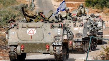 Israeli army tracked medical vehicles move along a road near the northern town of Kiryat Shmona close to the border with Lebanon on October 31, 2023 amid increasing cross-border tensions between Hezbollah and Israel as fighting continues in the south with Hamas militants in the Gaza Strip. (AFP)
