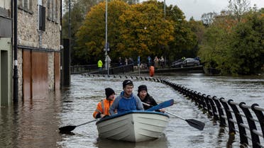 People row a boat through water as it flows through streets after heavy rain caused extensive flooding, ahead of the arrival of Storm Ciaran, in the city centre of Newry, Northern Ireland, October 31, 2023. REUTERS/Clodagh Kilcoyne TPX IMAGES OF THE DAY