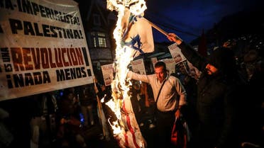 People burn a flag of Israel and the United States, during a vigil coined Palestine Lives, to show support for the Palestinians in the latest Israel-Hamas war, in Bogota, Colombia, Tuesday, Oct. 17, 2023. (AP)