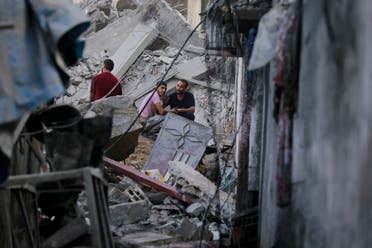 Palestinians gesture as they check the destruction in the aftermath of an Israeli strike in the Jabalia camp for Palestinian refugees in the Gaza Strip, on November 1, 2023, amid ongoing battles between Israel and the Palestinian Hamas movement. (AFP)