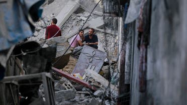 Palestinians gesture as they check the destruction in the aftermath of an Israeli strike in the Jabalia camp for Palestinian refugees in the Gaza Strip, on November 1, 2023, amid ongoing battles between Israel and the Palestinian Hamas movement. (AFP)