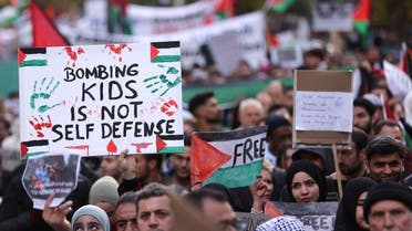Demonstrators hold placards during a protest in solidarity with Palestinians in Gaza, amid the ongoing conflict between Israel and the Palestinian group Hamas, in Duesseldorf, Germany, on October 21, 2023. (Reuters)