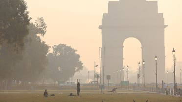 People exercise on a grass lawn near India Gate along 'Kartavya Path' on a smoggy morning in New Delhi, India, October 27, 2023. (Reuters)