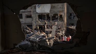 Palestinians look at the destruction after Israeli strikes on the Gaza Strip in Khan Younis, Saturday, Now. 4, 2023. (AP Photo/Fatima Shbair)