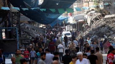 Palestinians walk in the street market of Jabaliya refugee camp, northern Gaza Strip, Wednesday, Nov. 1, 2023, after an Israeli airstrike. (AP Photo/Abed Khaled)