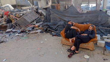 Palestinian Mohammed Hamdan, who lost 35 family members of three generations in an Israeli airstrike, rests on a couch near the rubble of his family home that was destroyed in the strike, in Khan Younis in the southern Gaza Strip, November 7, 2023. (Reuters)